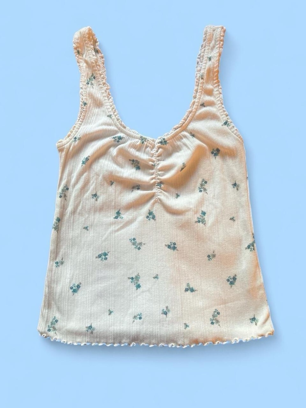 Old Navy white tank top with a blue floral print and ruffle trim in a size S